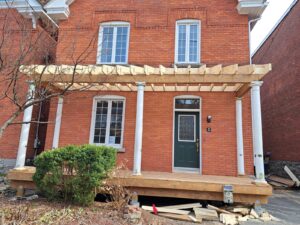 Front veranda rebuild on a red brick century home in Ottawa