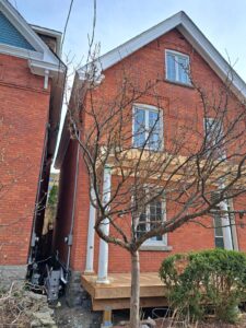 Front veranda rebuild on a red brick century home in Ottawa