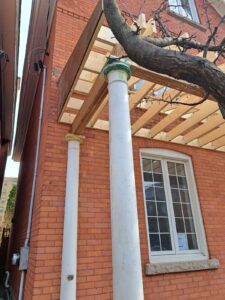 Front veranda rebuild on a red brick century home in Ottawa