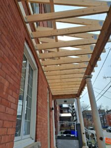 Front veranda rebuild on a red brick century home in Ottawa