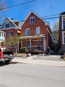 Front veranda rebuild on a red brick century home in Ottawa