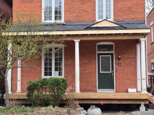 Front veranda rebuild on a red brick century home in Ottawa