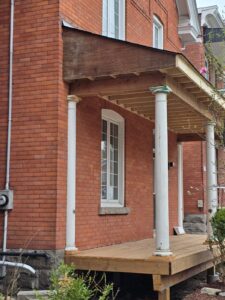 Front veranda rebuild on a red brick century home in Ottawa