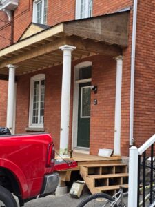 Front veranda rebuild on a red brick century home in Ottawa