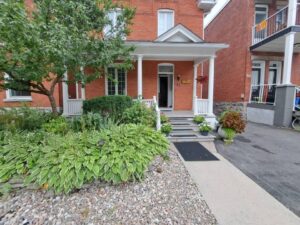 Front veranda rebuild on a red brick century home in Ottawa