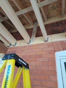 Front veranda rebuild on a red brick century home in Ottawa