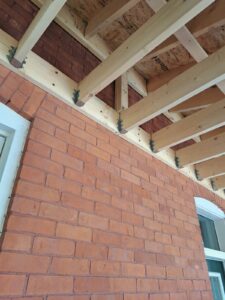 Front veranda rebuild on a red brick century home in Ottawa