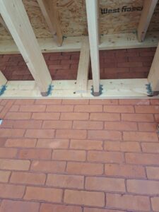 Front veranda rebuild on a red brick century home in Ottawa