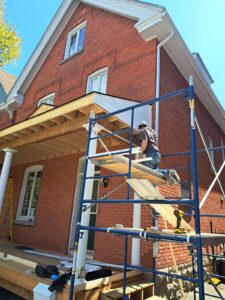 Front veranda rebuild on a red brick century home in Ottawa