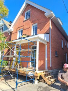 Front veranda rebuild on a red brick century home in Ottawa