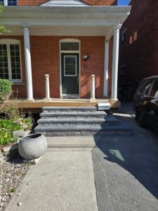 Front veranda rebuild on a red brick century home in Ottawa