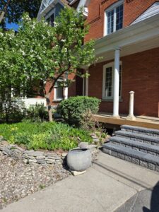 Front veranda rebuild on a red brick century home in Ottawa