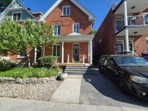 Front veranda rebuild on a red brick century home in Ottawa