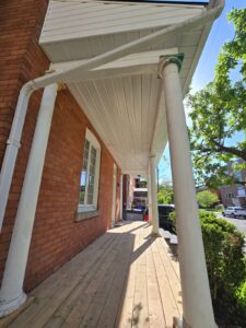 Front veranda rebuild on a red brick century home in Ottawa