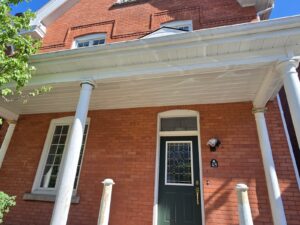 Front veranda rebuild on a red brick century home in Ottawa