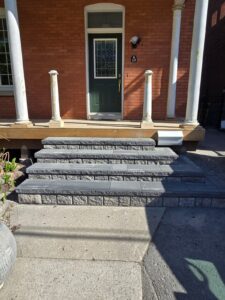Front veranda rebuild on a red brick century home in Ottawa