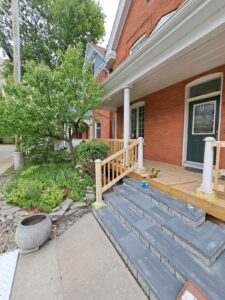 Front veranda rebuild on a red brick century home in Ottawa