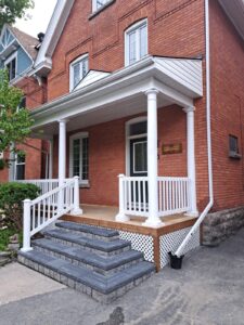 Front veranda rebuild on a red brick century home in Ottawa