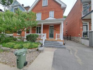 Front veranda rebuild on a red brick century home in Ottawa