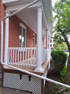 Front veranda rebuild on a red brick century home in Ottawa