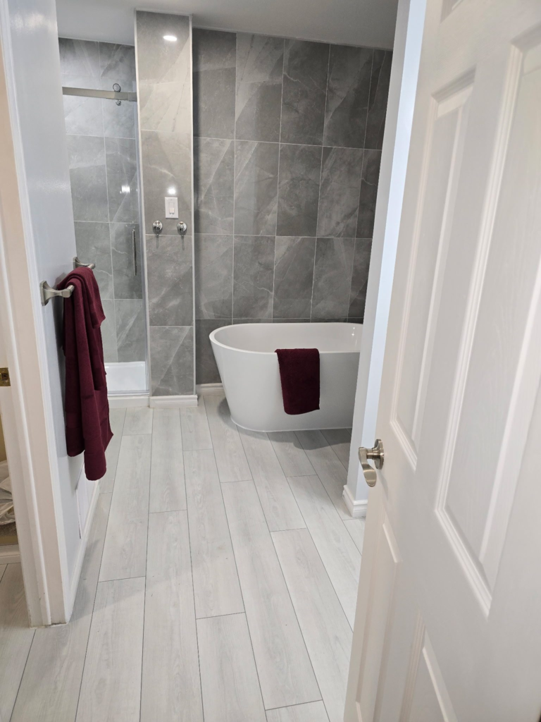 Finished glass shower and freestanding tub after an Ottawa bathroom renovation