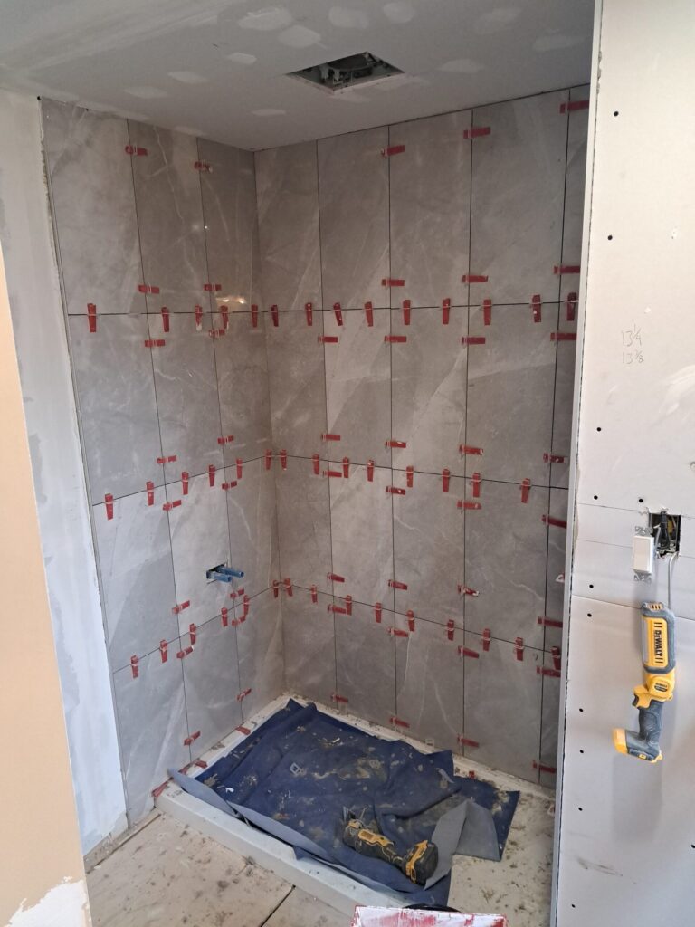 Shower wall being tiled during an Ottawa bathroom renovation